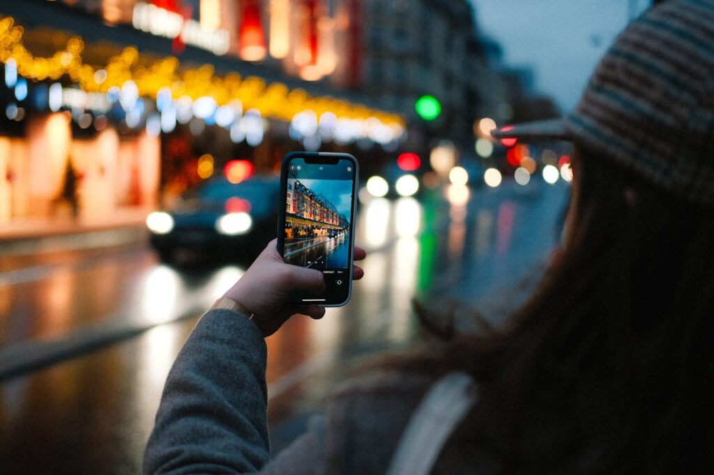 Woman Taking Picture of Street