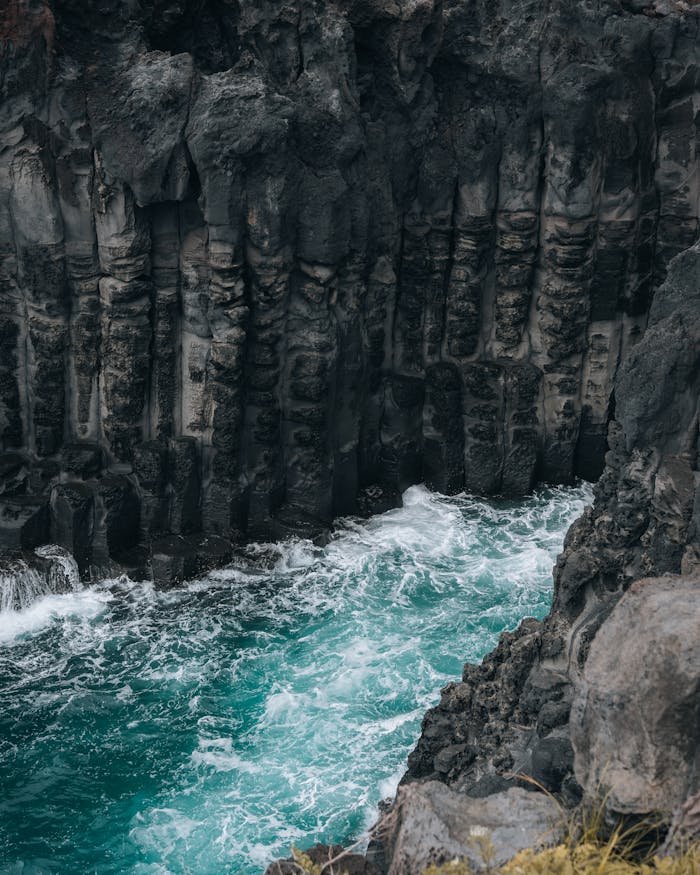 Stunning view of rugged cliffs and turquoise ocean in Jeju, ideal for nature and travel themes.