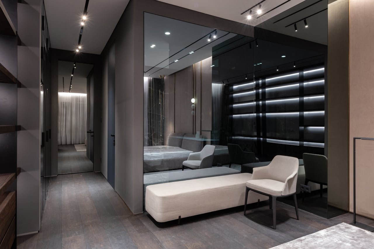 why-choose-us Interior design of bedroom with modern furniture and big mirror on wall in flat